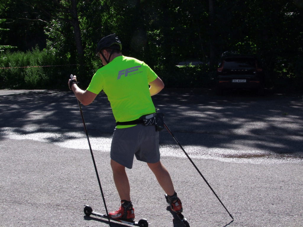 A person roller skiing on a sunny day, showing the different techniques used in the sport