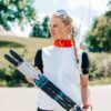 FF Rollerskis: Experience Summer Skiing Woman holding a pair of FF rollerskis outdoors.