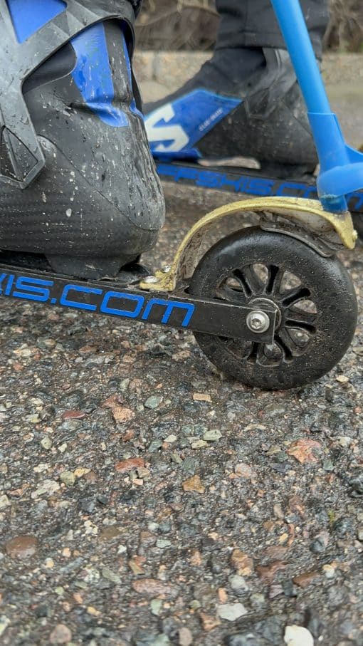 Rollerski with integrated brake fender activated by ski pole.