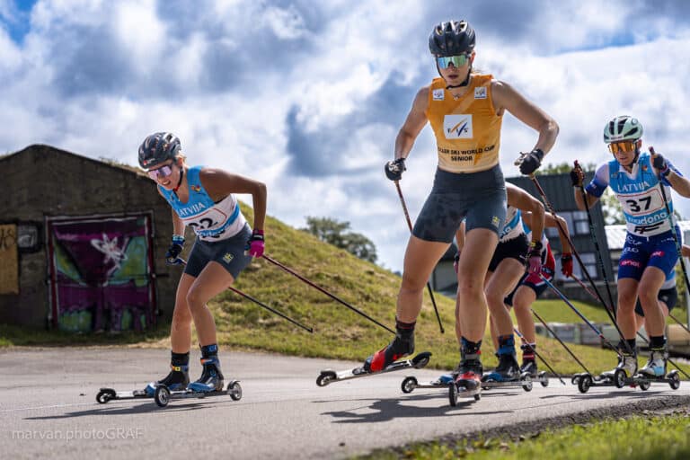 Elite women on FF Active Skate rollerskis compete at a FIS World Cup event, showcasing powerful skate technique.