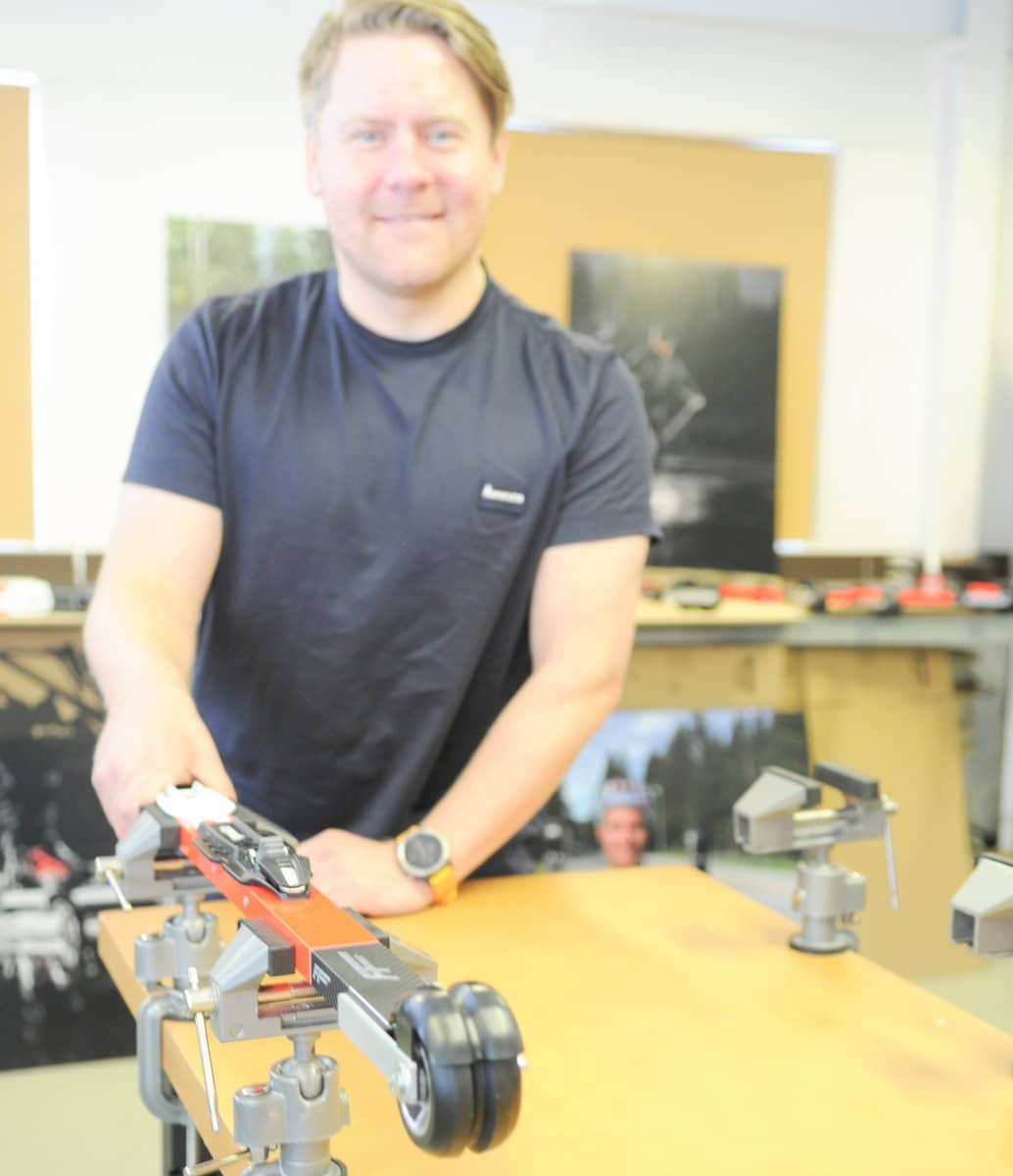 Henrik, CEO of FF Rollerskis, working on a pair of rollerskis in his professional workshop environment.