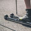 A skier using FF V Active Classic roller skis on a track, demonstrating stability and performance